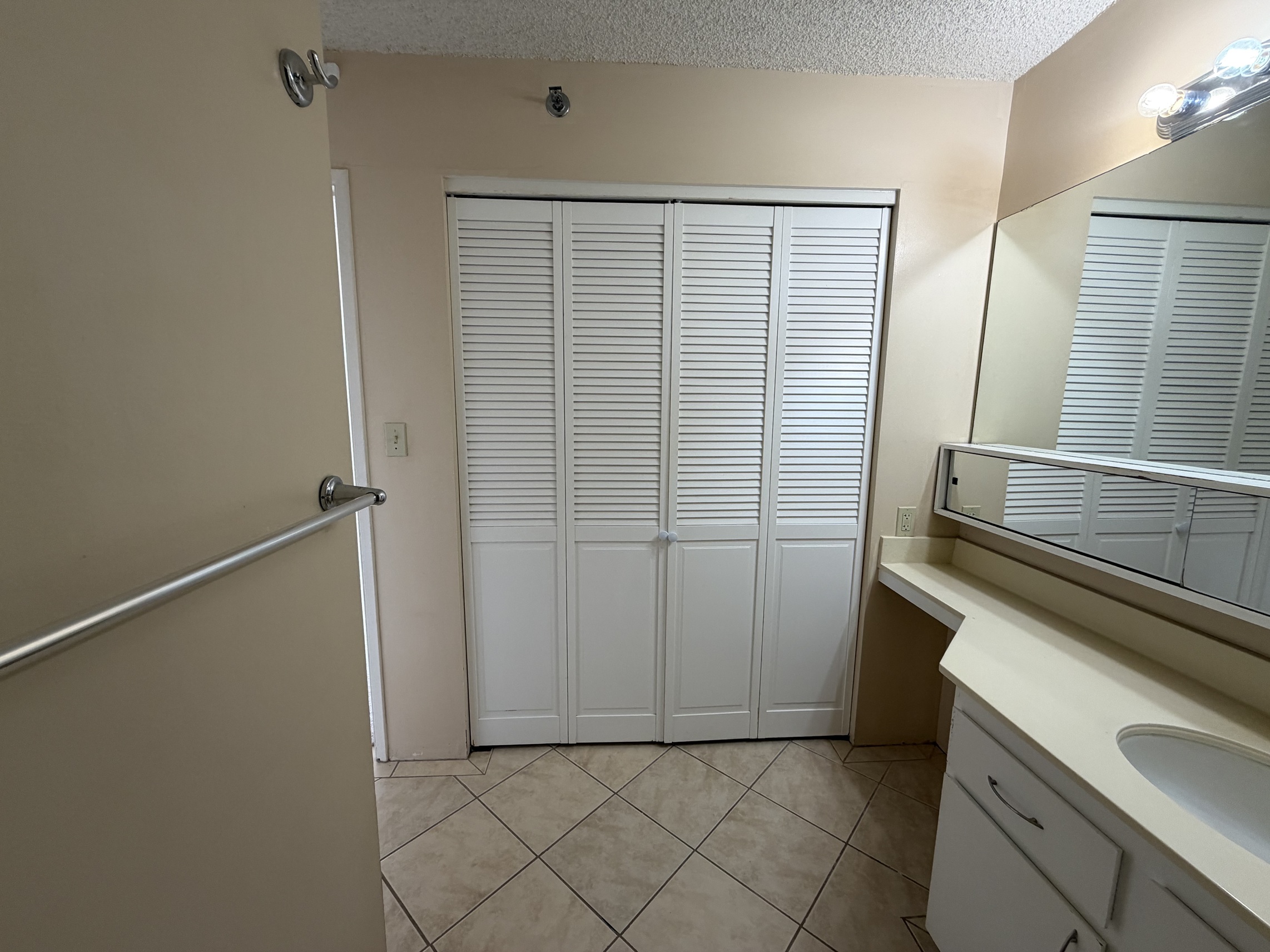 A bathroom with a white cabinet and a white sink.